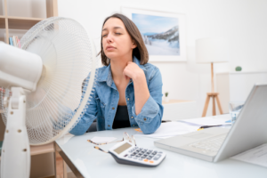 A woman sitting in front of a fan in a Richmond, VA, home.